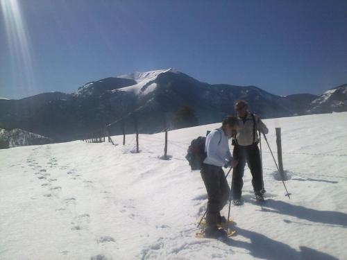 two people on skis on a snow covered mountain at Al Villino del Sole in Fano