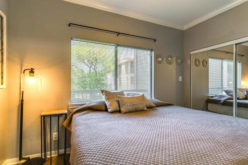 a bedroom with a bed and a large window at Lake Conroe Condo with Pool Access and Balcony! in Montgomery