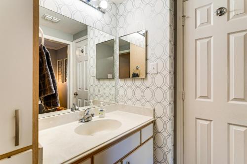 a bathroom with a sink and a mirror at Lake Conroe Condo with Pool Access and Balcony! in Montgomery