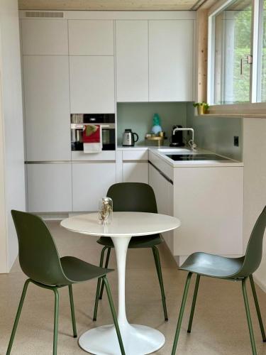 a kitchen with a white table and two chairs at Modernes Appartement "Mayfair" Zürich Balgrist & Spital in Zürich