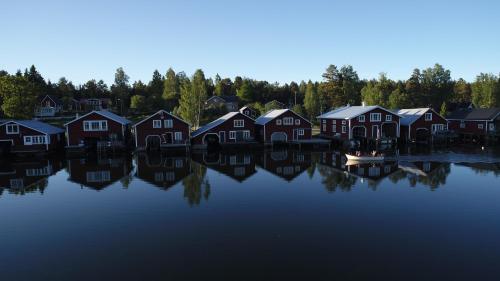 a group of houses sitting on the water at Hotell Mellanfjärden in Jättendal