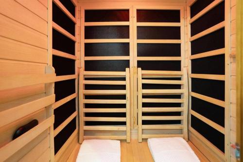 a walk in closet with wooden shelving at Romantic Luxury W Infrared Sauna in Beaufort