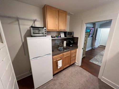 a kitchen with a white refrigerator and a sink at Romantic Luxury W Infrared Sauna in Beaufort