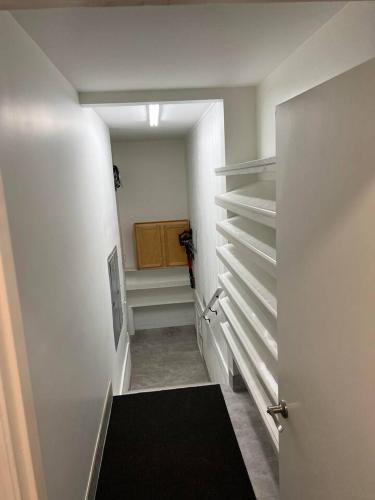 a hallway with a stairway leading to a closet at Romantic Luxury W Infrared Sauna in Beaufort