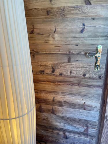 a wooden door with a handle on a wooden wall at Villa Anita San Vigilio di Marebbe in San Vigilio Di Marebbe
