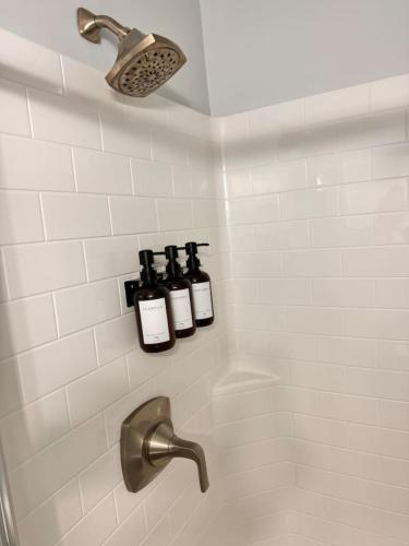 a shower with three bottles of wine on a wall at Cozy Studio Retreat. Pet Yes in Beaufort