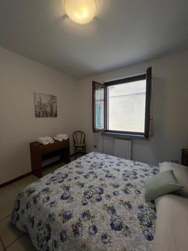 a bedroom with a bed and a window at In castello 1984 in Rovato