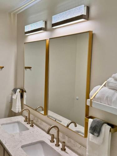 a bathroom with a sink and a large mirror at Newest Cottage Downtown. Pet Yes in Beaufort