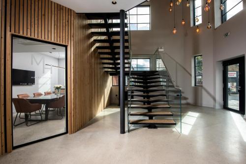 a spiral staircase in a room with a table at Montgomery House Apart-Hotel in Headingley