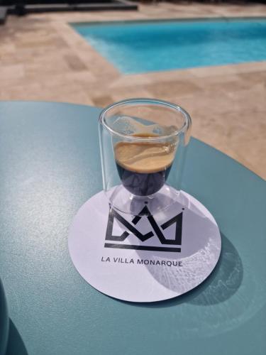 a drink in a glass on a coaster on a table at La Villa Monarque in Cap d'Agde