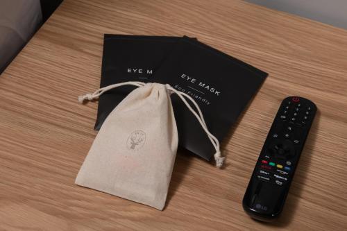 a bag sitting next to a remote control at Montgomery House Apart-Hotel in Headingley