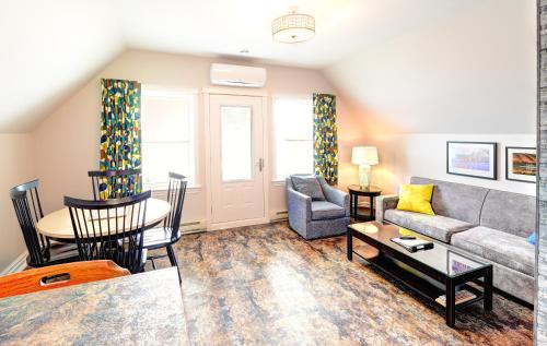 a living room with a couch and a table at Keltic Quay Cottages & Bayfront Lodge in Whycocomagh