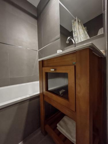 a bathroom with a sink and a shower at Gente del Sur - Buena Vista in Ushuaia