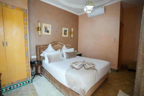 a bedroom with a large white bed in a room at Palais Zahia Hotel & Spa in Tangier