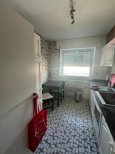 a kitchen with a table and chairs and a window at Red Dot Eva in Werne an der Lippe