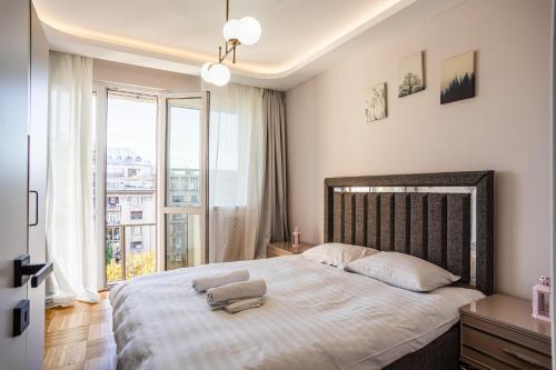 Ένα ή περισσότερα κρεβάτια σε δωμάτιο στο Central Accommodation on Magheru Boulevard