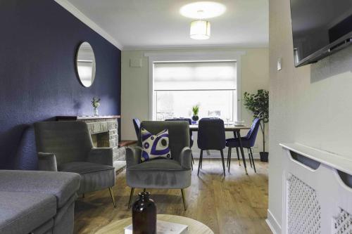a living room with a couch and a table with chairs at Cochran House in Bathgate