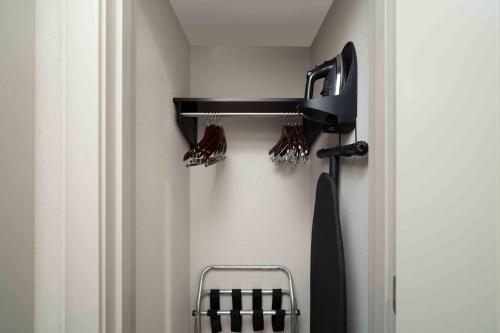 a room with a closet with a hair dryer at Homewood Suites By Hilton Boston Logan Airport Chelsea in Chelsea