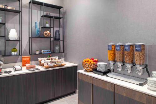 a kitchen with a counter with food on it at Homewood Suites By Hilton Boston Logan Airport Chelsea in Chelsea