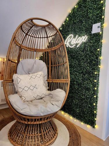 a rattan bird cage with a pillow in it at Lovely Calm Boho Spa & Sauna in Quebec City