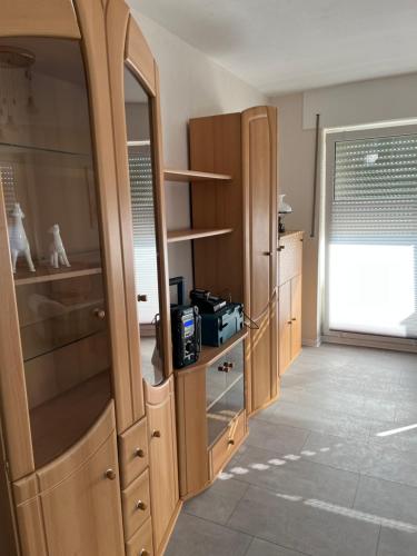 a kitchen with wooden cabinets and a large window at Red Dot Eva in Werne an der Lippe