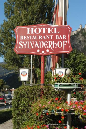 a sign for a hotel restaurant bar with flowers at Hotel & Residence Sylvanerhof in Chiusa