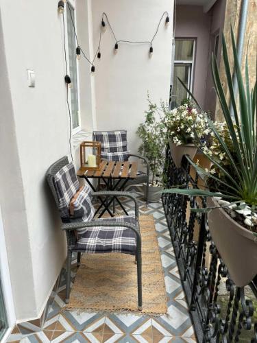 a balcony with chairs and a table and plants at Fiesta Apartment on Franka 2BR-6P in Lviv