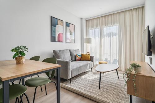 a living room with a couch and a table at Truliving Vallecas by Habyt in Vallecas