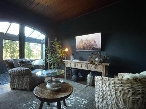 a living room with a couch and a table at Alma Hotel in Campos do Jordão