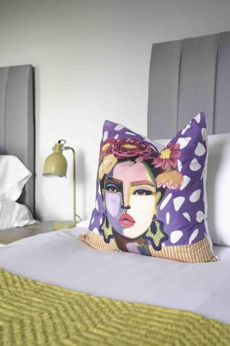a pillow with a picture of a woman on a bed at Pentland House in Bathgate