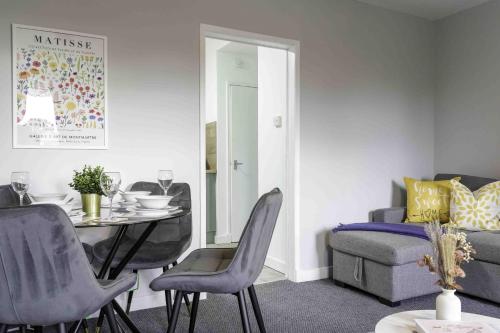 a living room with a table and chairs and a couch at Pentland House in Bathgate
