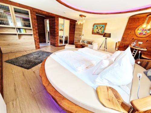 una camera da letto con un grande letto bianco in una stanza di Luxus Romantik Apartment mit Whirlpool und Sauna a Ottenhöfen im Schwarzwald