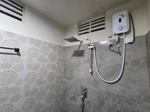 a shower stall in a bathroom with a shower at Ceylon Resort Wilpattu in Wilpattu