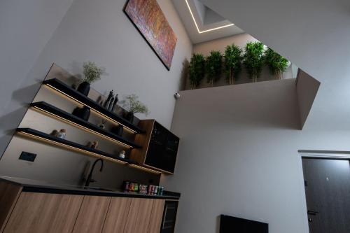 a living room with plants on the wall at Montgomery House Apart-Hotel in Headingley