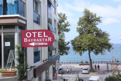 a sign on the side of a building next to the water at Bayraktar Hotel in Akcakoca