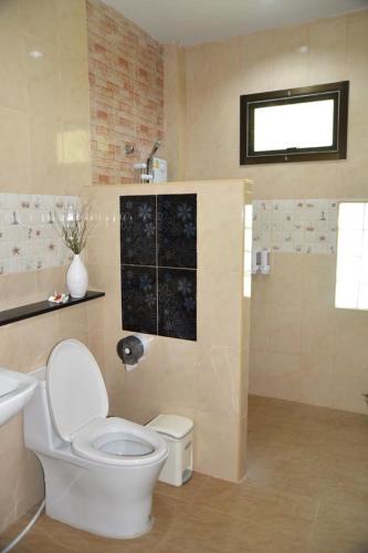 a bathroom with a toilet and a sink at Rasa sayang Resort - SHA Certificate in Ko Lanta