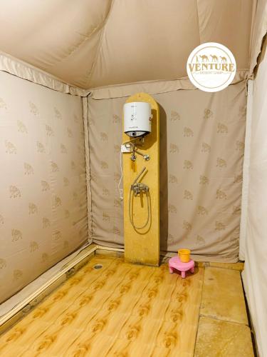 a room with a shower in a tent at Venture Desert Camp Jaisalmer in Jaisalmer