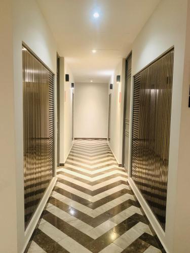 a hallway with a checkered floor in a building at 1 block from the Ocean and 5thAV in Playa del Carmen