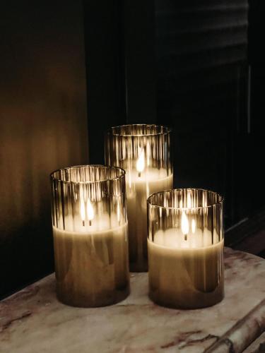 three candles sitting on top of a table at ASTRID Mons in Mons