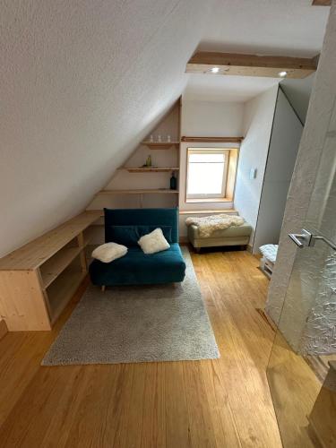 a living room with a blue couch in the attic at Little Blue Cottage #7 in Fehmarn