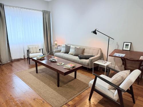 a living room with a couch and a table at Porto Vintage House in Porto