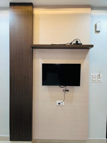 a flat screen tv on a wall in a room at Hotel Rama in Gorakhpur