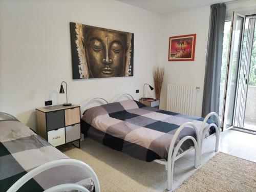 a bedroom with a bed with a face on the wall at B&B Ariosto 26 in Rho