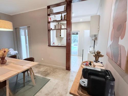 a living room with a table and a dining room at Porto Vintage House in Porto