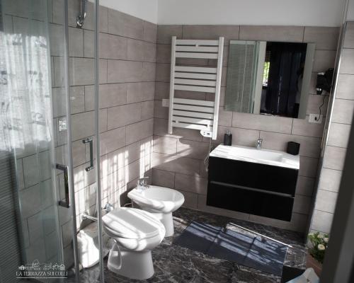 a bathroom with a sink and a toilet and a mirror at B&B La Terrazza sui Colli in Rome