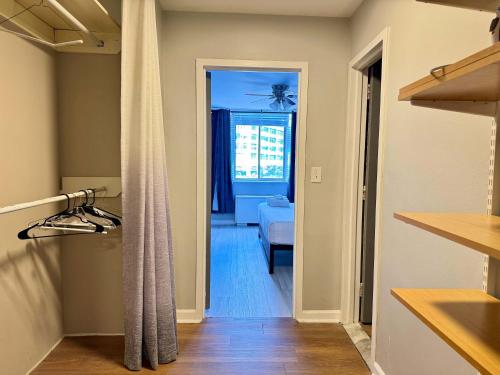 a hallway with a door leading to a living room at Atlanta Downtown! Onsite Parking! 2BD! City View! LM509 in Atlanta