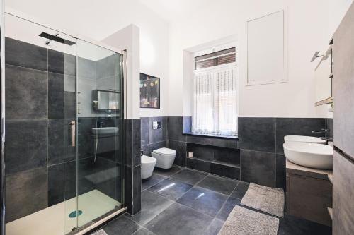 a bathroom with a glass shower and a sink at palmaria suite -the duck nest in Genoa