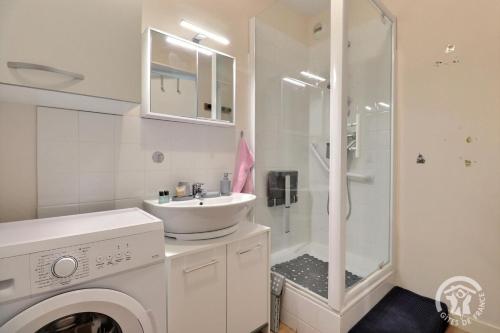 a white bathroom with a sink and a shower at Le sens de breizh in Sens-de-Bretagne