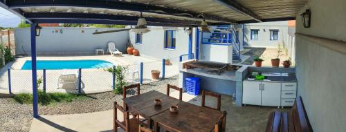 a patio with a table and a swimming pool at Departamentos La Justina in Cafayate
