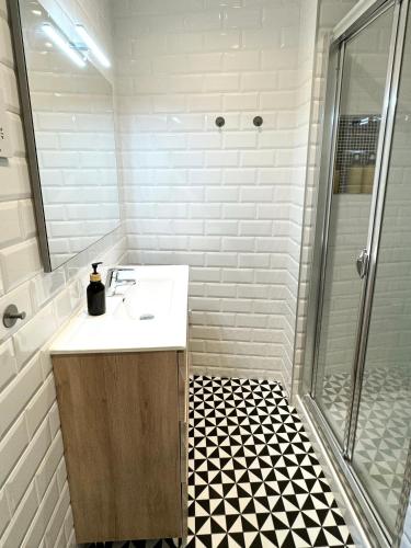 a bathroom with a sink and a shower at Modern City Centre Two Bedroom Windsor Apartment - Grand Central House in Gibraltar